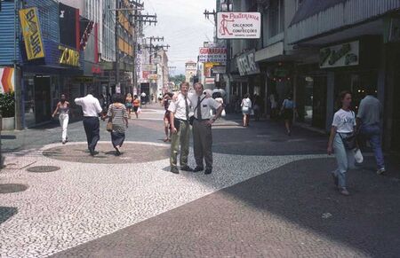 Elder Lords and Elder Henrie on the streets in Florianópolis. This is a very typical street. Notice the sidewalk. It's actually made of little stones about 1