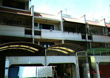 Our apartment in Tainan, on Dong Men Lu.  Ours is the one with the open garage door.
Chad 孫耀威 Snelson
30 Mar 2003