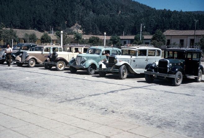 This photo is of the Taxi fleet at the train station in Constitucion at Christmas time, December, 1962.

The Elders of the Central District (Curico, Talca & Linares) were gathered here to celebrate Christmas.  This view is what greeted us as we deboarded the train.  And we used them to get to our hotel.
Andrew Milton Jensen
09 Feb 2013